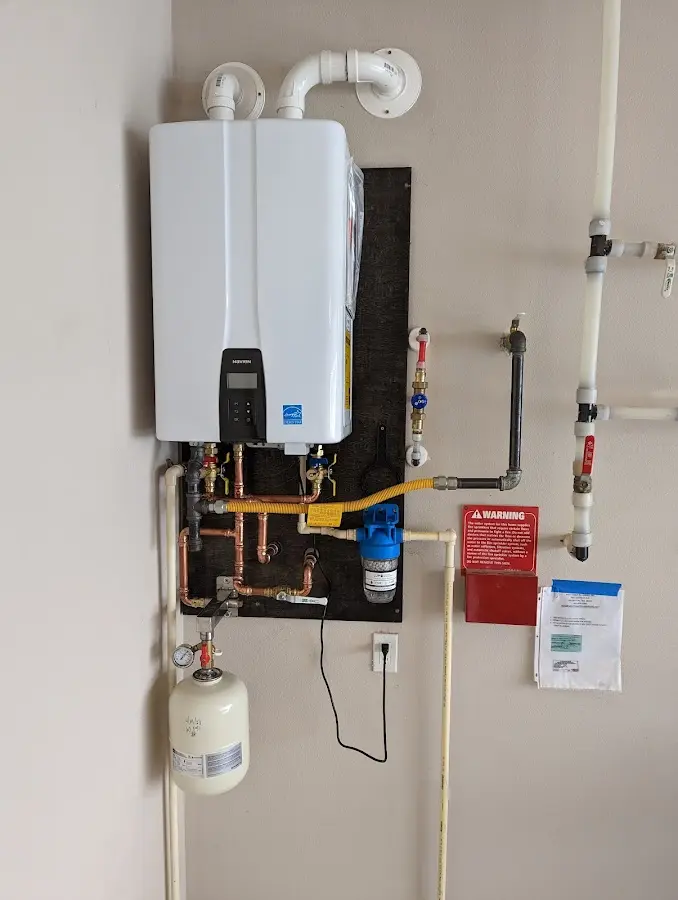 Professional plumber installing copper piping in a Morrisville home